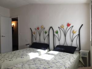 パンプローナにあるApartamento Mañuetaのベッドルーム1室(花の壁画が壁に施されたベッド1台付)