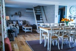 a dining room with a table and chairs and a couch at Maison Marie in Poperinge