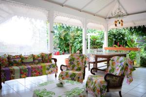 a living room with chairs and a table at Villa Tangara - Faa'a - Tahiti - 3 bedrooms - pool and lagon view - 6 pers in Faaa