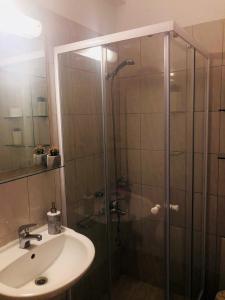 a bathroom with a shower and a sink at Lovely Apartments D in Patra +19 photos