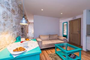 a living room with a table and a couch at Historical Old town apartments in Dubrovnik