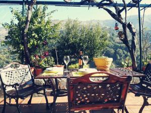 a table and chairs on a patio with a view at Cortijo Buenavista in Málaga