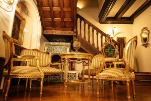 a room with chairs and a table and a staircase at Scala Boutique-Hotel in Bucharest