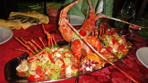 a plate of food with lobster and salad on a table at Hotel Corsaro Nero in Portu Maga