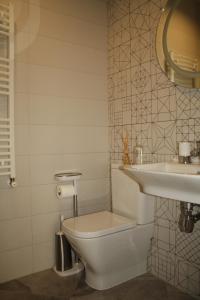a bathroom with a toilet and a sink at LVIV WALL STREET APT in Lviv