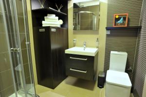 a bathroom with a toilet and a sink and a shower at Holiday House Lena in Poreč +25 photos