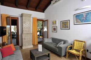 a living room with a couch and a chair at Holiday House Lena in Poreč