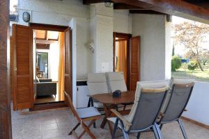 a table and chairs on the porch of a house at Holiday House Lena in Poreč