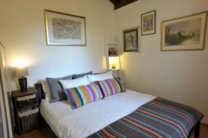a bedroom with a bed with a colorful pillow at Holiday House Lena in Poreč