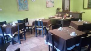 a dining room with tables and chairs and green walls at Casa Rural Mirabueno in Cuenca +14 photos