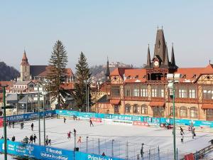 a group of people skating on an ice rink at Casa Schei in Braşov