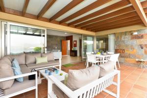 a living room with a couch and a table at Salobre Villa with Pool Par 4 nr 9 in Salobre