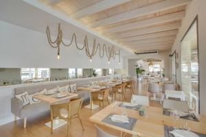a dining room with tables and chairs in a restaurant at C´AN PICAFORT NEAR THE SEA in Can Picafort