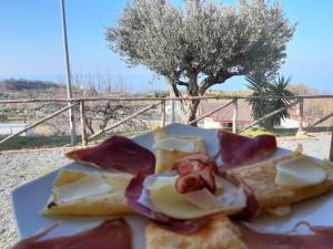 a plate of food with eggs and bread on it at Agriturismo Agri Armonia in San Lucido