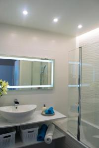 a bathroom with a sink and a glass shower at Dream park in Montévrain +38 photos