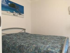 a bedroom with a bed and a picture on the wall at Chambre du verger in Francheville