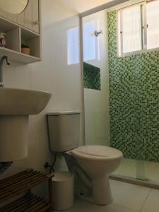 a bathroom with a toilet and a shower at Apartamento frente Mar Santos in Santos