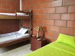 a bedroom with two bunk beds and a brick wall at Sol de Playa in Playas