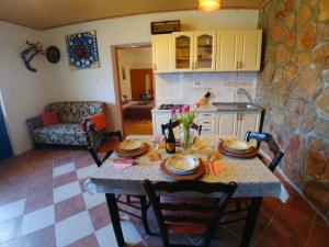 a living room with a table and a kitchen at Apartments Marija in Karlobag