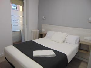 Säng eller sängar i ett rum på Hostal I Dream Salamanca