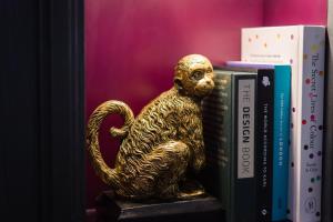 a statue of a bear sitting on top of a book shelf at Vintry & Mercer in London
