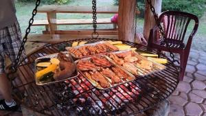 a grill with many different types of food on it at Pod Kogutem in Piecki