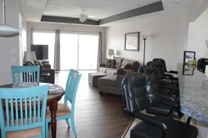a living room with a couch and a table and chairs at Lake Ozarks Get Away in Lake Ozark