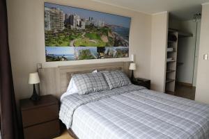 a bedroom with a bed with a picture on the wall at Miraflores Apartments 570 Pardo Ave by Private Host in Lima +67 photos