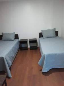 מיטה או מיטות בחדר ב-Hostal Alessandri