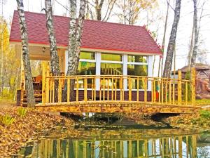 a house on a bridge over a body of water at Fairy house in Petrovo