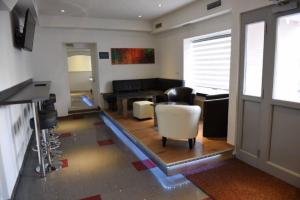 a living room with a couch and a table and chairs at Center Rooms Villach in Villach