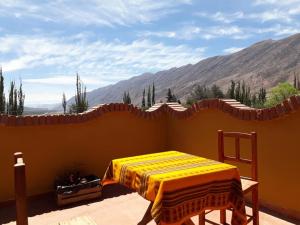 a bedroom with a bed with a view of the mountains at Carnavalito Hostel Tilcara in Tilcara