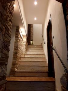 a staircase in a building with a stone wall at Case Brizi Assisi in Assisi