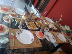 a table with plates of food on it at Olivi Palace in Udawalawe