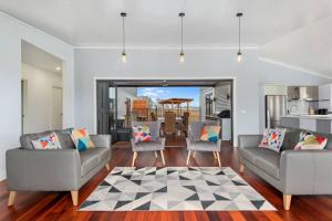 a living room with two couches and a kitchen at 3 WISE MONKEYS, MANSFIELD in Mansfield