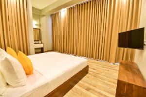 Voodi või voodid majutusasutuse Hiriketiya Beach Resort toas