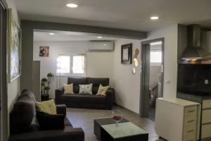 a living room with a couch and a table at Casa Nossominho in Vila Nova de Cerveira