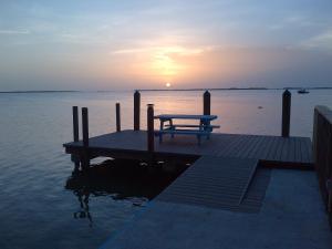 a wooden dock with a picnic table on the water at Seafarer Key Largo Resort and Beach in Key Largo