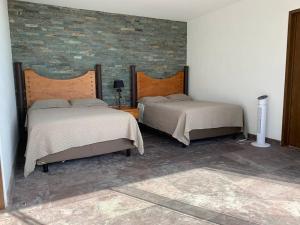 A bed or beds in a room at Casa de las Aves - Alberca y Jacuzzi climatizados - Espectaculares vistas