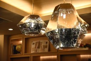 two glass pendant lights hanging from the ceiling at Compass Hotel Nagoya in Nagoya