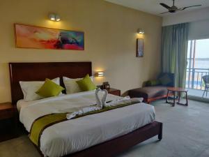 Postel nebo postele na pokoji v ubytování Hotel Sonar Bangla Taki