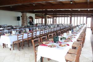 a long row of tables and chairs with food on them at Hotel Corsaro Nero in Portu Maga