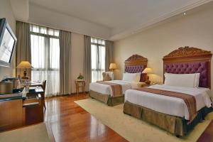 a large hotel room with two beds and a television at Royale Chulan Kuala Lumpur in Kuala Lumpur +37 photos