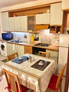 a kitchen with a table with chairs and a white refrigerator at Romantic Venice in Venice +5 photos
