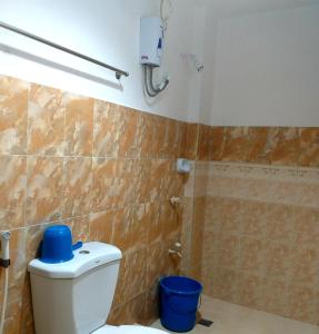 a bathroom with a toilet and a shower at Park Vil-la Apartelle in Manila