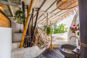 a room with a bunch of bats hanging on a wall at Le Cliff Bali in Uluwatu