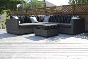 a black couch sitting on a patio at Willow Bend Motel in Truro