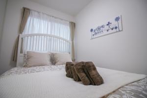 a bedroom with a bed with a blanket on it at CASA Higashi Mikuni 02 in Osaka