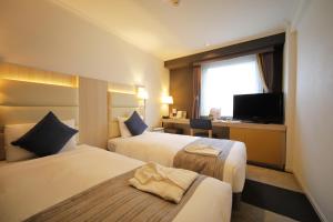 Postel nebo postele na pokoji v ubytování Hotel Sunroute Stellar Ueno