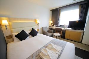 Postel nebo postele na pokoji v ubytování Hotel Sunroute Stellar Ueno